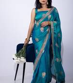 Women's turquoise embellished soft silk blend saree with unstitched piece