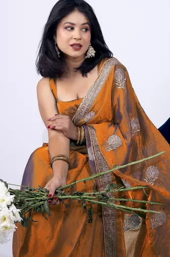 Women's orange embellished soft silk blend saree with unstitched piece