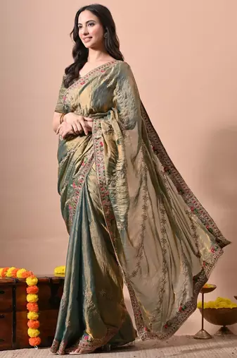Women's green embellished soft silk blend saree with unstitched piece