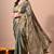 Women's green embellished soft silk blend saree with unstitched piece