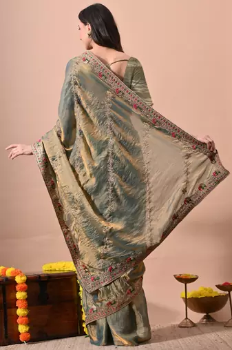 Women's green embellished soft silk blend saree with unstitched piece