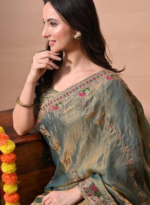 Women's green embellished soft silk blend saree with unstitched piece 5