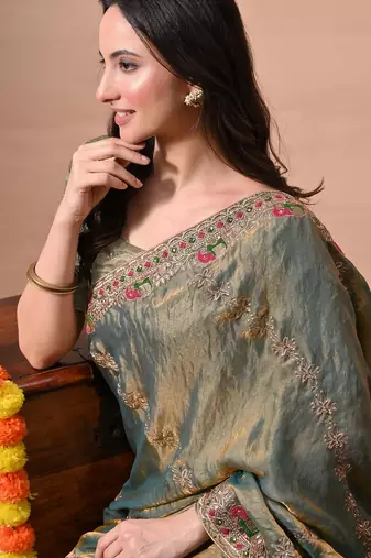 Women's green embellished soft silk blend saree with unstitched piece