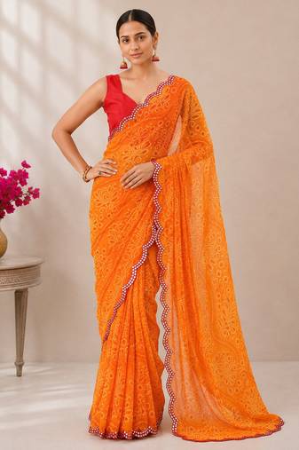 Orange bandhani printed saree with mirror work & cutwork border