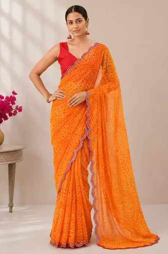 Orange bandhani printed saree with mirror work & cutwork border