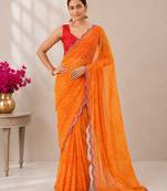Orange bandhani printed saree with mirror work & cutwork border