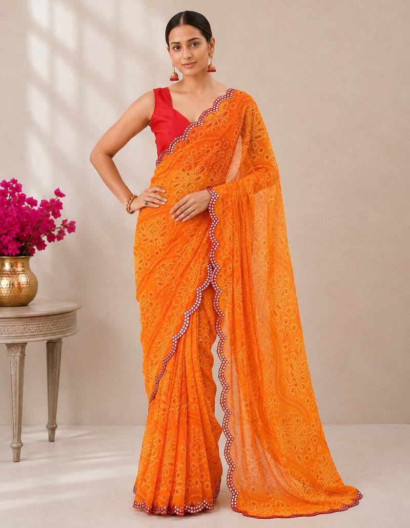 Orange bandhani printed saree with mirror work & cutwork border