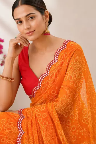 Orange bandhani printed saree with mirror work & cutwork border