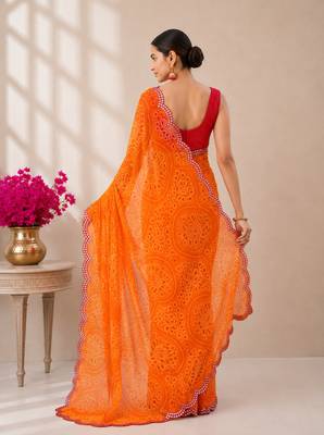 Orange bandhani printed saree with mirror work & cutwork border 3