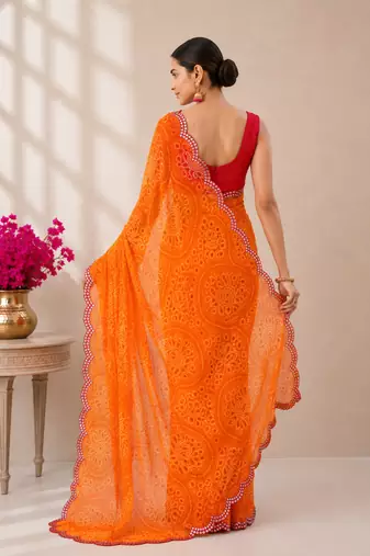 Orange bandhani printed saree with mirror work & cutwork border