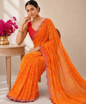 Orange bandhani printed saree with mirror work & cutwork border 4