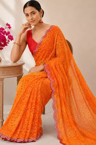 Orange bandhani printed saree with mirror work & cutwork border