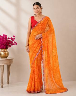 Orange bandhani printed saree with mirror work & cutwork border 5