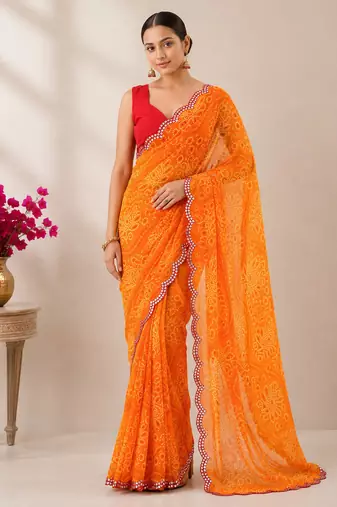 Orange bandhani printed saree with mirror work & cutwork border