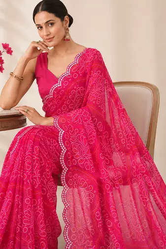 Pink bandhani printed saree with mirror work & cutwork border