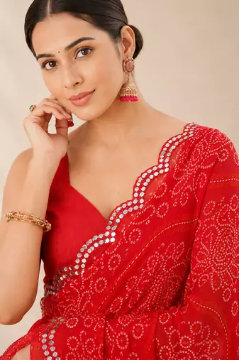 Red bandhani printed saree with mirror work & cutwork border