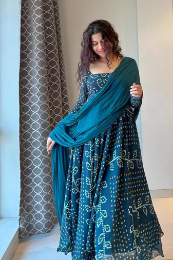 Teal-blue faux georgette embroidered flared gown set