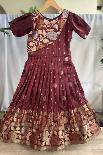 Charming girls frock with intricate floral weaving and a stylish panel design