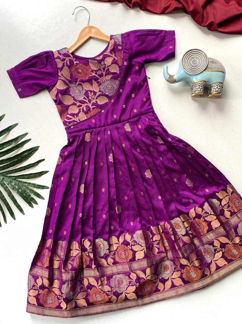 Charming girls frock with intricate floral weaving and a stylish panel design