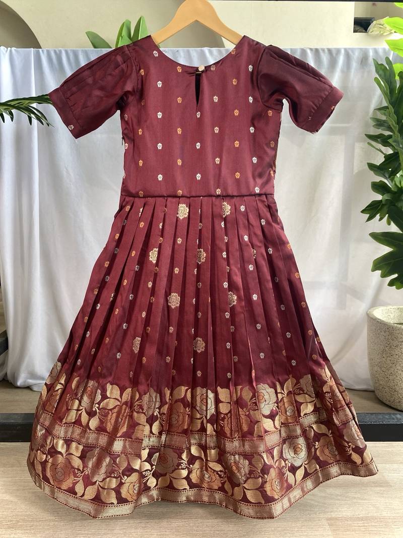 Charming girls frock with intricate floral weaving and a stylish panel design