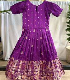 Charming girls frock with intricate floral weaving and a stylish panel design