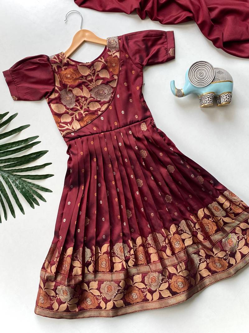 Charming girls frock with intricate floral weaving and a stylish panel design