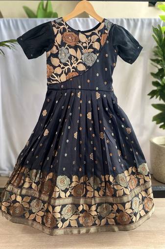 Charming girls frock with intricate floral weaving and a stylish panel design