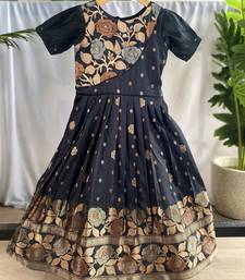 Charming girls frock with intricate floral weaving and a stylish panel design