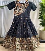 Charming girls frock with intricate floral weaving and a stylish panel design