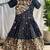Charming girls frock with intricate floral weaving and a stylish panel design