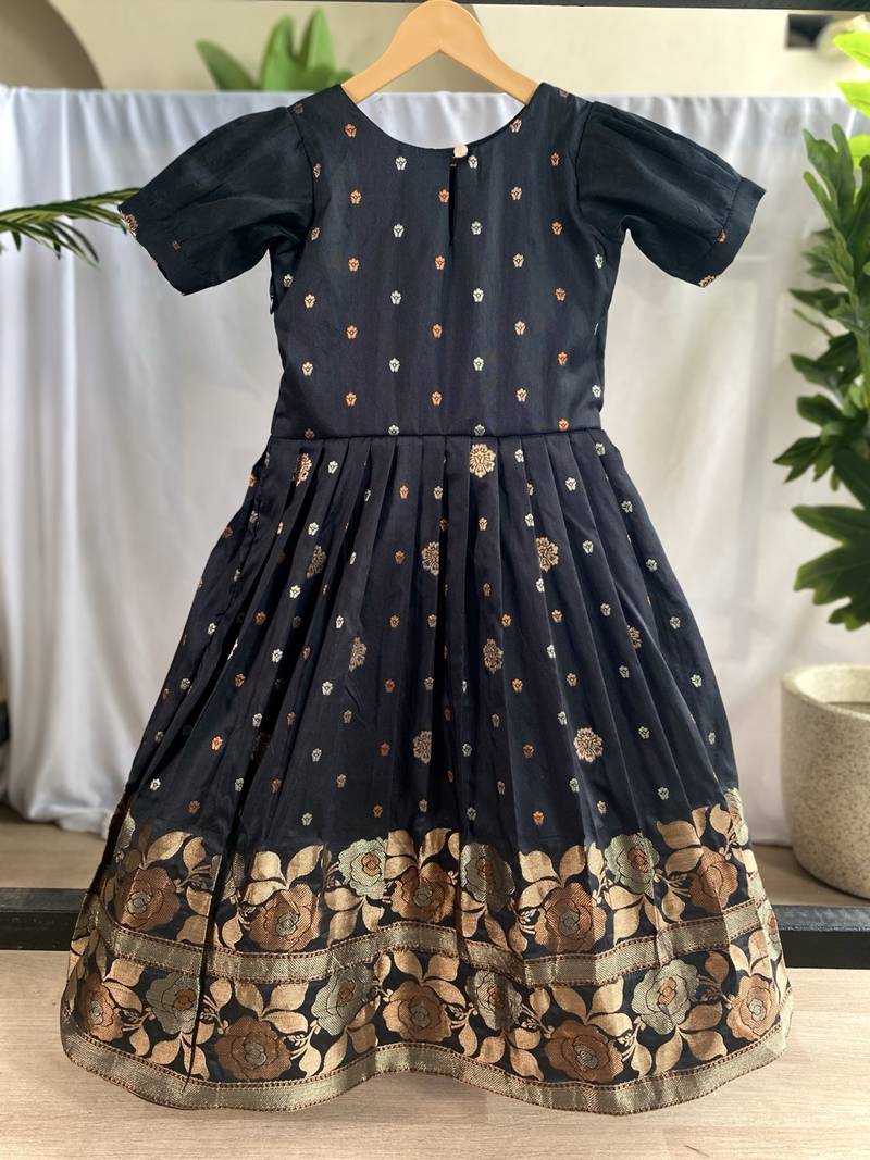 Charming girls frock with intricate floral weaving and a stylish panel design