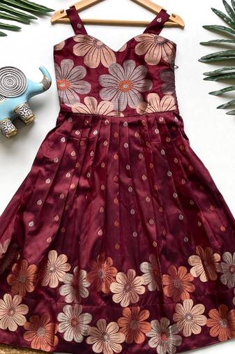 Charming girls frock with intricate floral weaving and a stylish panel design