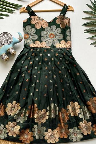 Charming girls frock with intricate floral weaving and a stylish panel design