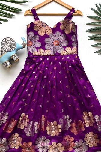 Charming girls frock with intricate floral weaving and a stylish panel design