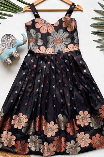 Charming girls frock with intricate floral weaving and a stylish panel design