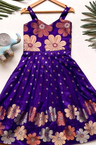 Charming girls frock with intricate floral weaving and a stylish panel design