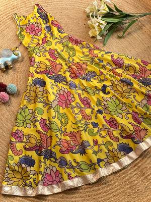 Yellow tussar silk gown for girls features a vibrant pen kalamkari floral print 1