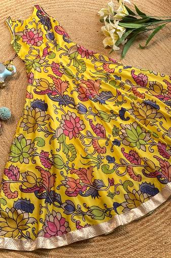 Yellow tussar silk gown for girls features a vibrant pen kalamkari floral print