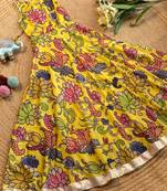 Yellow tussar silk gown for girls features a vibrant pen kalamkari floral print