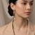 Gold plated gilded knot dangler earrings
