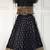 Black ethnic skirt and top set featuring an elegant border design with intricate woven motifs