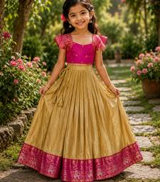 Gold silk tissue skirt paired with a soft silk top, adorned with a contrast pink border