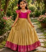 Gold silk tissue skirt paired with a soft silk top, adorned with a contrast pink border