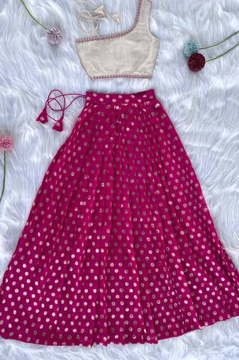 Pink one-shoulder solid crop top with polka dot flared lehenga for girls