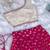 Pink one-shoulder solid crop top with polka dot flared lehenga for girls