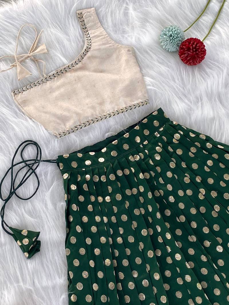 Green one-shoulder solid crop top with polka dot flared lehenga for girls