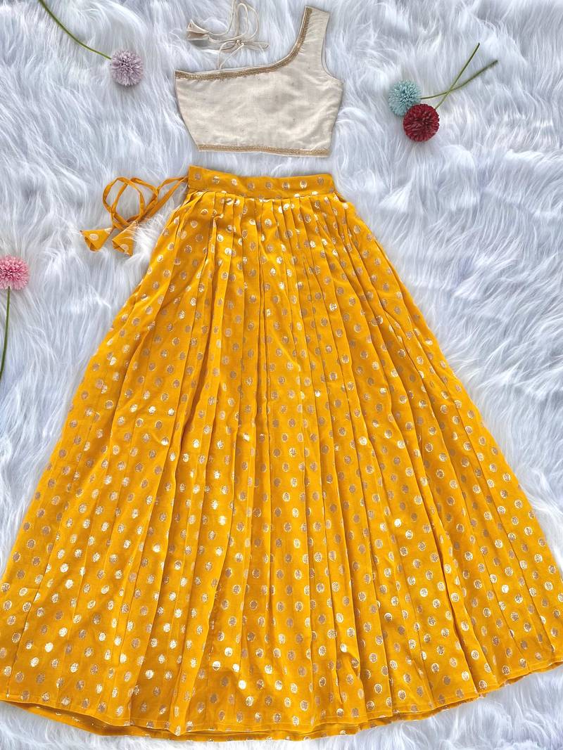 Yellow one-shoulder solid crop top with polka dot flared lehenga for girls