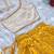 Yellow one-shoulder solid crop top with polka dot flared lehenga for girls
