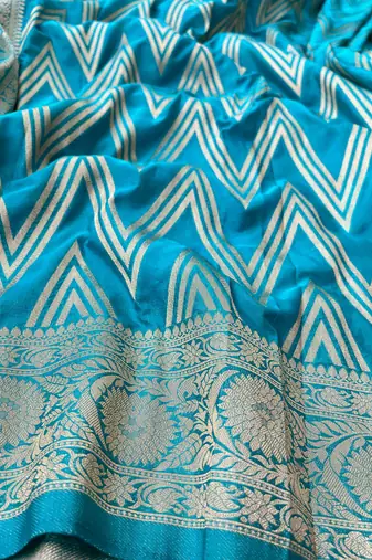 Teal Blue Woven Golden Zari Chevron Pattern Design Fabric Pure Soft Chinon/Georgette Saree With Blouse Unstitched