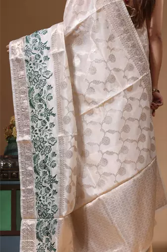 Off-white banarasi silk (jacquard) with computer embroidery saree with blouse piece